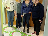 Students and Special Education Teacher Krista Everson pose on the snake feature of the new Sensory Walk.