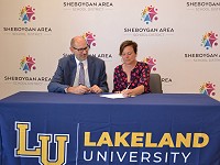 Lakeland University President Beth Borgen signs the new agreement between SASD and Lakeland University.