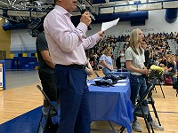 TMJ4's Lance Allan speaks to the crowd at North High School.