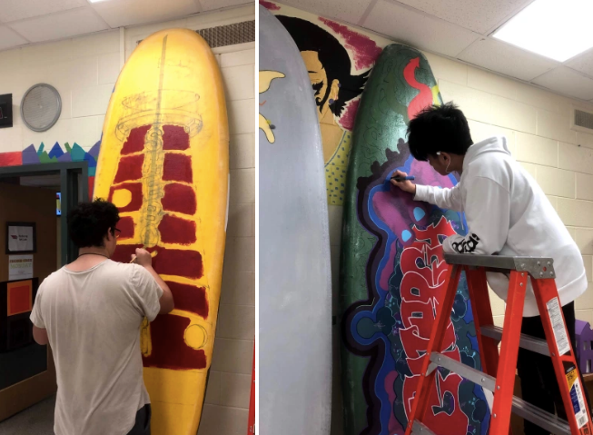 students painting surfboards