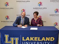SASD Superintendent Seth Harvatine signs the new agreement between SASD and Lakeland University.
