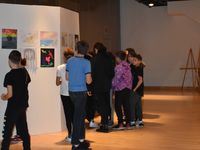 Sheboygan Area School District Etude Middle School. Photo of Etude Middle School students looking at an art gallery.