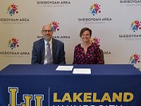 Superintendent of SASD Seth Harvatine and Lakeland University President Beth Borgen smile after signing the agreement.