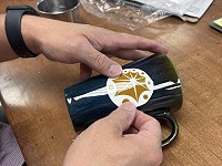applying the logo decal to the mug