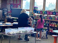 James Madison student choosing a book at the Great Start Conferences