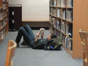 Sheboygan Area School District North High School. Student at North High School reading in the library.