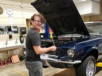 North High Schoool student Kaden Gorges works on his 1967 Mustang