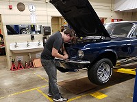 North High Schoool student Kaden Gorges works on his 1967 Mustang