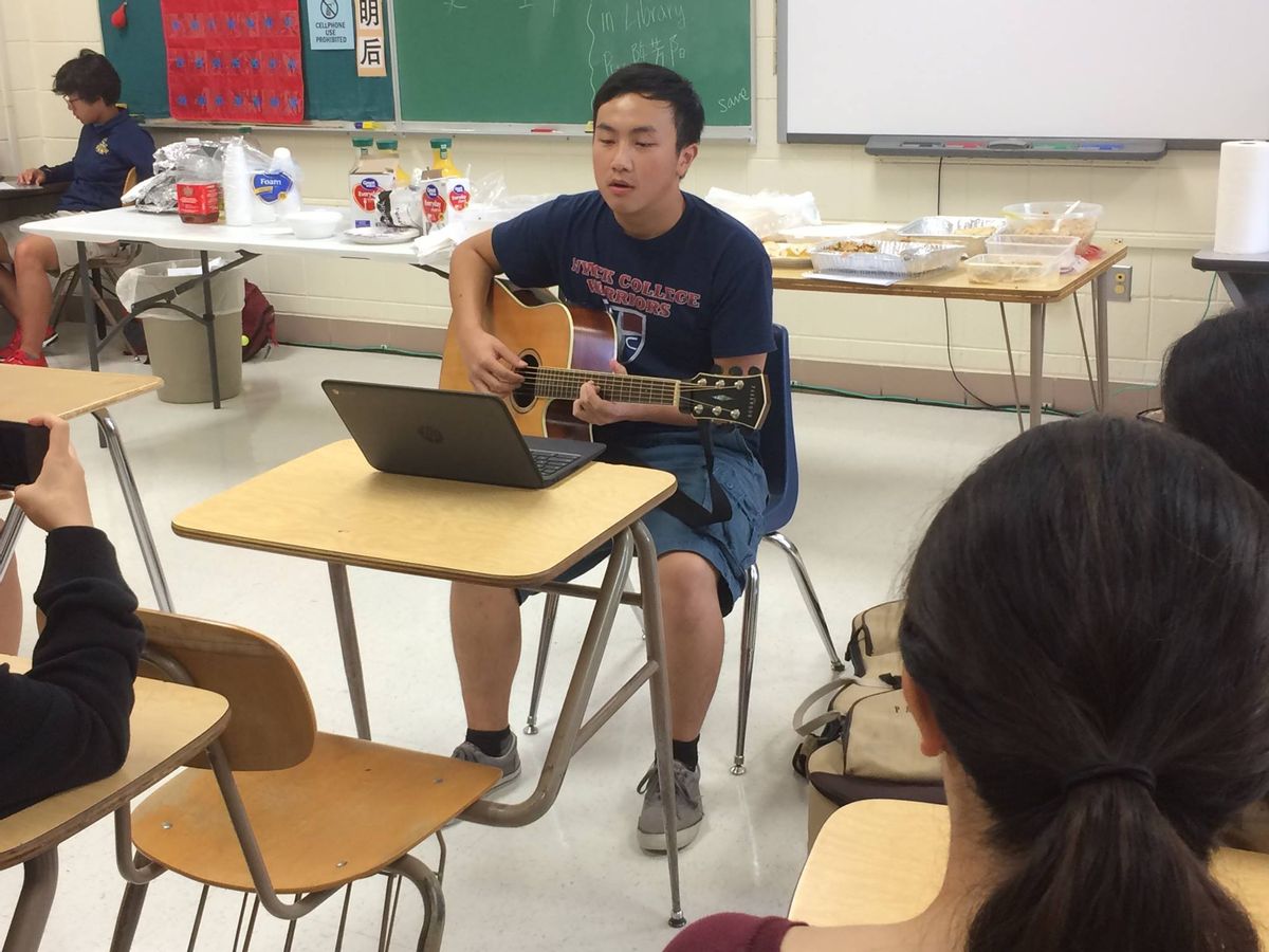 Sheboygan Area School District North High School. Photo of North High School Student playing guitar.