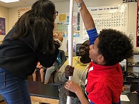 students building a very tall paper tower