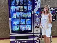 Early Literacy Interventionist (ELI) teacher Kim Reinhart poses with the new Book Vending Machine.